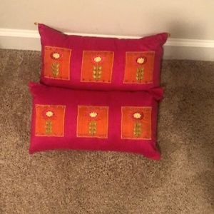 Pink oblong pillows with floral decoration